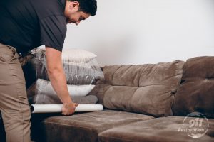 disaster restoration technician packing up furniture