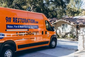 911 Restoration van parked in front of residence
