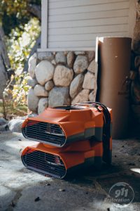 water damage restoration equipment on front porch