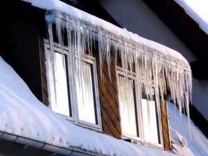 ice dams forming in gutter of house